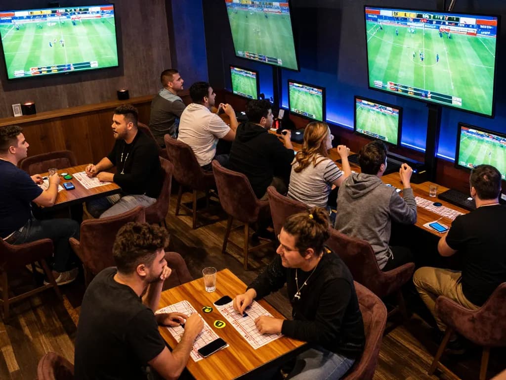 Cakhiatv users eagerly placing bets in an electrifying sports betting lounge atmosphere